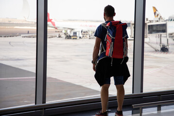 Obraz premium handsome man with backpack waiting in airport