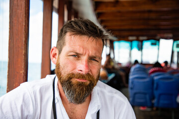 handsome caucasian man travelling on a local ferry