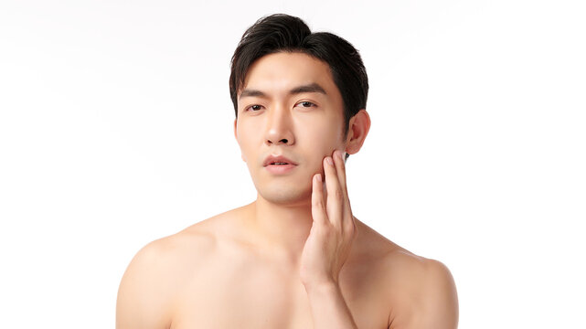 Portrait of shirtless young handsome Asian man for skincare and beauty concepts against on white background,