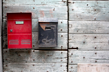 Old and new Mailbox on a wooden door