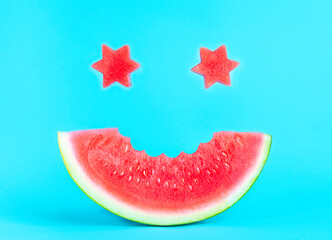 A smile of watermelon on a blue background, star eyes