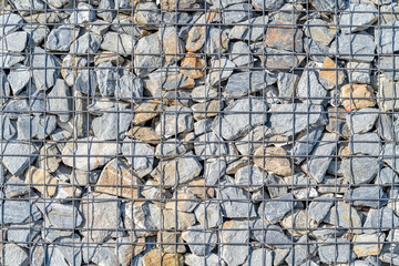 a stone fence in a wire frame. background with copy space