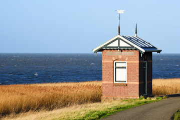 Westerland, Netherlands. February 2023. A monitoring station at the border of the Wadden Sea. - obrazy, fototapety, plakaty