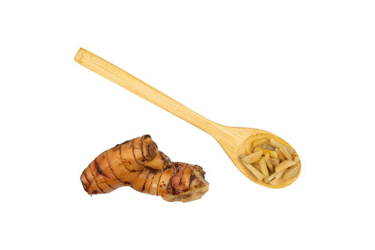 Galangal in a wooden spoon isolated