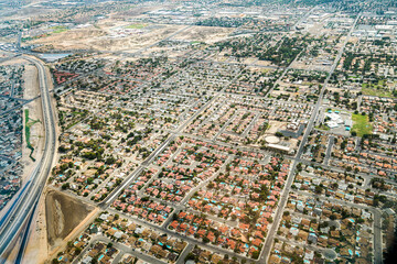 Aerial view of a geometric residential area with bungalows. Each house has a pool. This suburban housing complex is in a geometrical form.