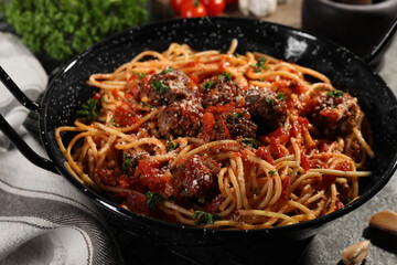 Delicious pasta with meatballs and tomato sauce on grey table, closeup