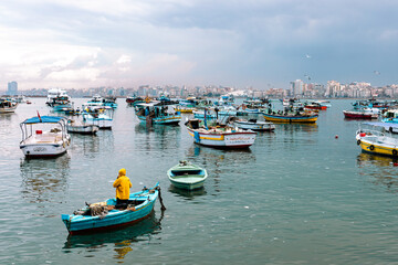 Fototapeta na wymiar Harbor of Fishing Boats Floating on Blue Sea Water, Alexandria, Egypt. Africa.