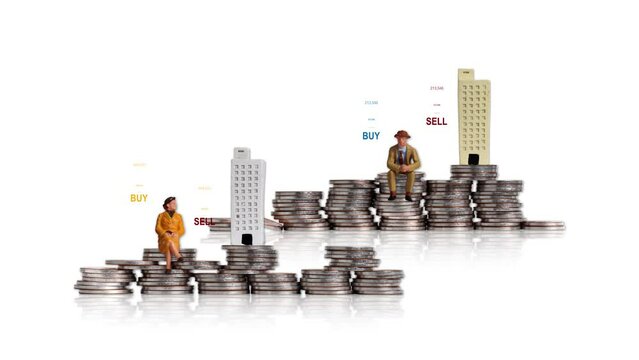 Miniature people sitting and miniature buildings on piles of coins. Concept of price fluctuations and investment success strategies in the housing market.
