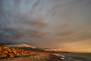 Sunset on the Black Sea coast with mountains in the background