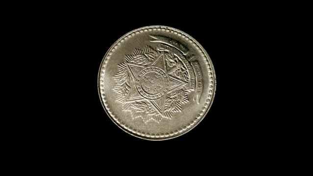 Reverse of an old Brazil coin with the image of coat of arms of Brazil, isolated in white background. Close up view.