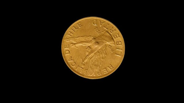 Obverse of Chile coin 10 pesos 1989 with image of a woman breaking the chains, isolated in black background. 4k video