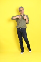 Fototapeta premium The 40s adult Asian man with casual dressed standing on the yellow background.