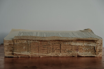 Old book on a copper surface. Book without cover. Book restoration.Copy space.