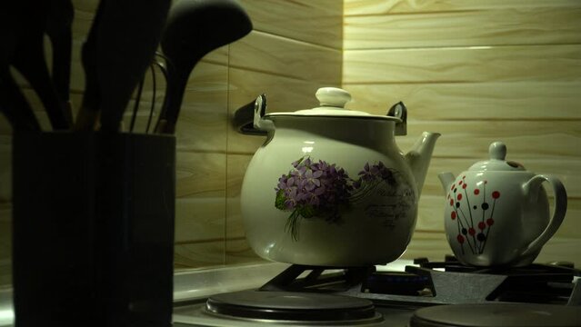 In the gas stove, the kettle is placed next to the kettle in a classic form