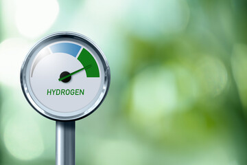 Hydrogen gauge with tree colors - gray, blue and green. Arrow points to green. Concept of green hydrogen production.