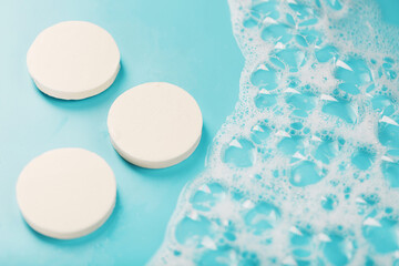 Three round pieces of white soap with foam