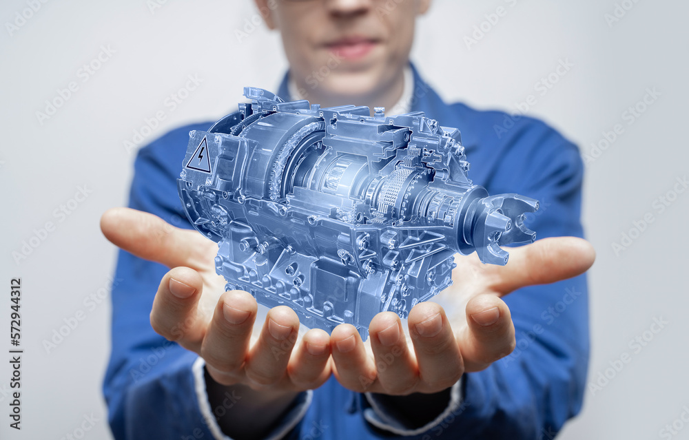 Poster Development engineer holds in his hands a model of an electric motor created in augmented reality.