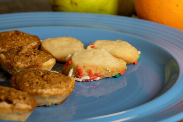 Cookies and fruit on a blue plate. High quality photo