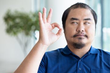 Blind man giving ok hand gesture for okay, all correct, good, yes, positive, approving gesture