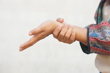 Asian woman having muscle weakness in her hands