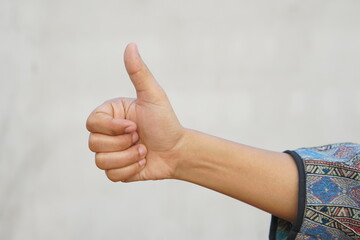 Asian woman raising hand showing great sign