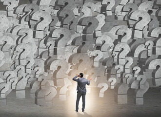 Businessman facing questions in business