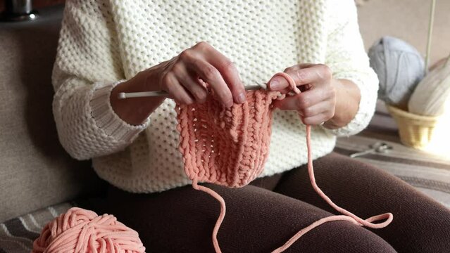 Close-up of women's hands knitting with yarn. Hobbies for women