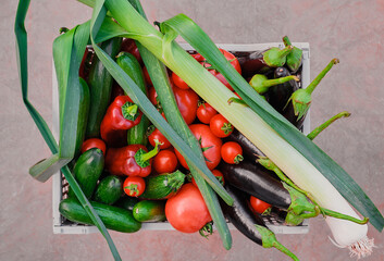 Top view of a basket with fresh seasonal vegetables from the farmer's market, fresh natural...