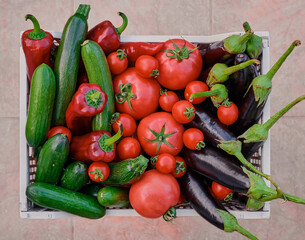 basket with fresh seasonal vegetables from the farmer's market, fresh natural seasonal products with delivery for a healthy and varied diet, the basis of a fulfilling life, top view