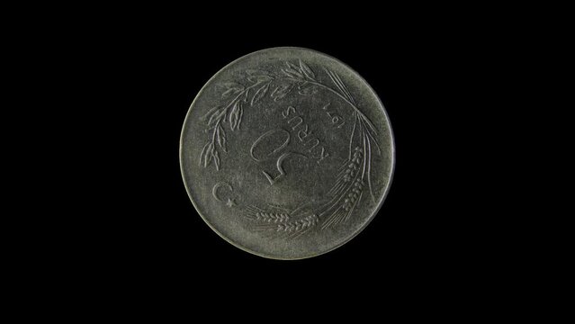 Rotating reverse of old Turkey coin 50 kurus 1971, isolated in black background. 4k video.