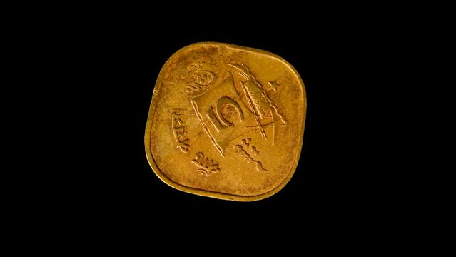 Reverse of old Pakistan coin 5 paisa with image of a vessel and inscription meaning FIVE PAISA, isolated in black background. 4k video.