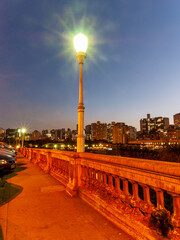Lamppost on Sapuca&iacute; Street at dusk in the city of Belo Horizonte. Viaduct Santa Teresa. Commercial buildings in the corner of the city. Vertical.