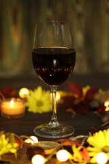 glass of red wine with autumn decoration