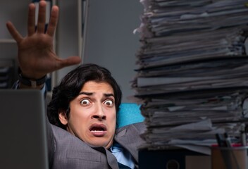 Young male employee working late at office