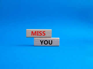 Miss you. Concept word Miss you on wooden cubes. Beautiful blue background. Business and Miss you concept. Copy space.