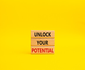 Unlock your Potential symbol. Wooden blocks with words Unlock your Potential. Beautiful yellow background. Business and Unlock your Potential concept. Copy space.