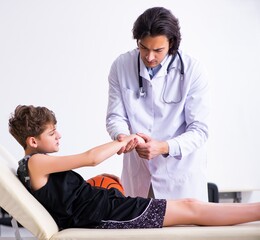 Boy basketball player visiting young doctor traumatologist