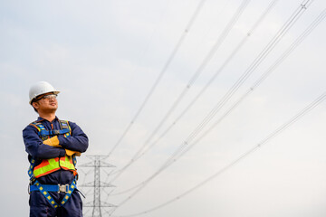 electric worker standing at power station to work at the power plant Electrician worker planning renewable energy production at high voltage pole