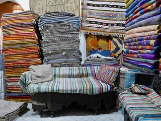 Colorful Berber carpets in shop in Medina of Marrakech, Morocco.