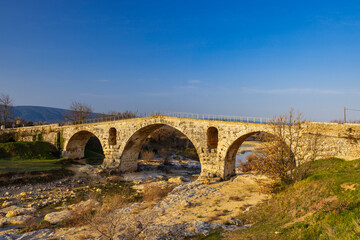Fototapeta na wymiar Pont Julien, roman stone arch bridge over Calavon river, Provence, France