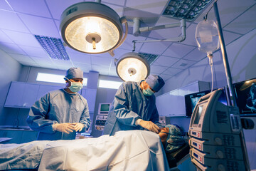 Medical Team Performing Surgical Operation in Modern Operating Room, Serious surgeons during a surgery in the hospital.