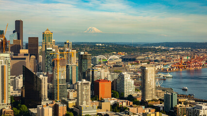 Seattle downtown. Skyscrapers on a background of blue sky. Mount Rainier, covered in snow, is on the horizon.