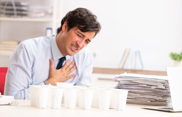 Young employee addicted to coffee