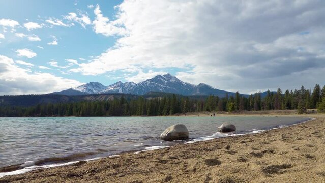 Lake Annette lake shore beach, Pyramid mountain reflection on the lake. Jasper National Park stunning nature scenery in summer time. Landscape of Canadian Rockies, Alberta, Canada.