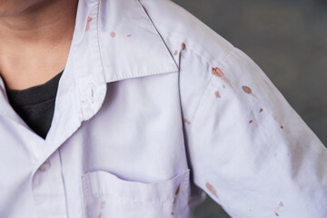chocolate stain on white shirt of kid from eating in daily life for cleaning concept idea