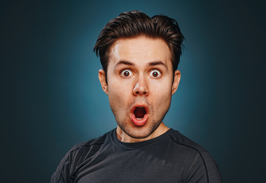 Young man with funny big head emotional wow portrait