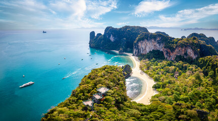 Aerial view of the beautiful Hong island in Thailand with lush greenhills and golden beaches surrounded by emerald sea - obrazy, fototapety, plakaty