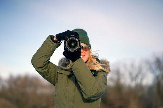 Woman taking photo in winter 