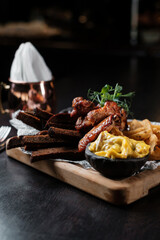 Beer snacks. Chicken wings, french fries and sauces.
