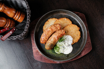 Fried sausages with potato pancakes